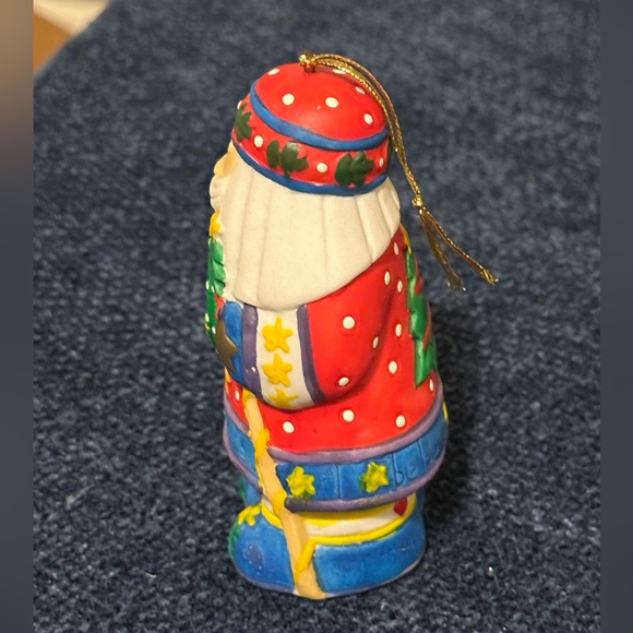 Brightly colored ceramic Santa ornament. Santa carries a tree & wreath. - Picture 4 of 10